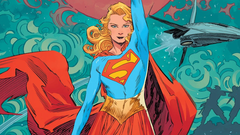 Supergirl holds up a space ship