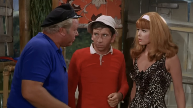 Bob Denver's Gilligan stands between Alan Hale Jr's Jonas Grumby and Tina Louise's Ginger Grant in Gilligan's Island