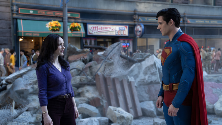 Lois Lane and Superman stand in front of some rubble in Superman (2025)