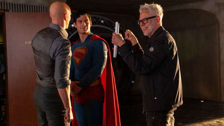 Director James Gunn laughing with actors David Corenswet as Superman and Nicholas Hoult as Lex Luthor on the set of Superman