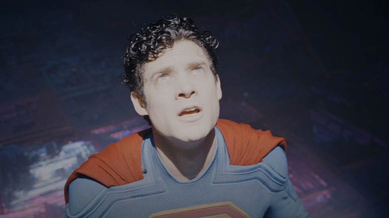 David Corenswet's Superman is iluminated by bright light as he looks up in Superman