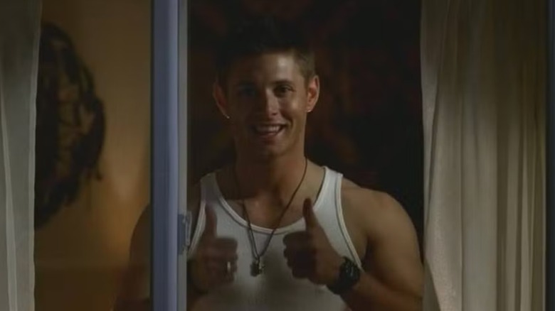 Decan Winchester Jensen Eckls gives double fingers out of the sanatorium window in supernatural