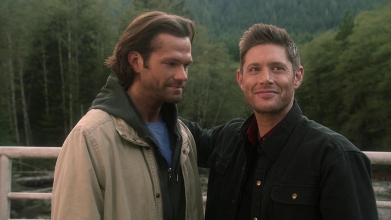 Sam and Dean Winchester stand on a bridge in Supernatural