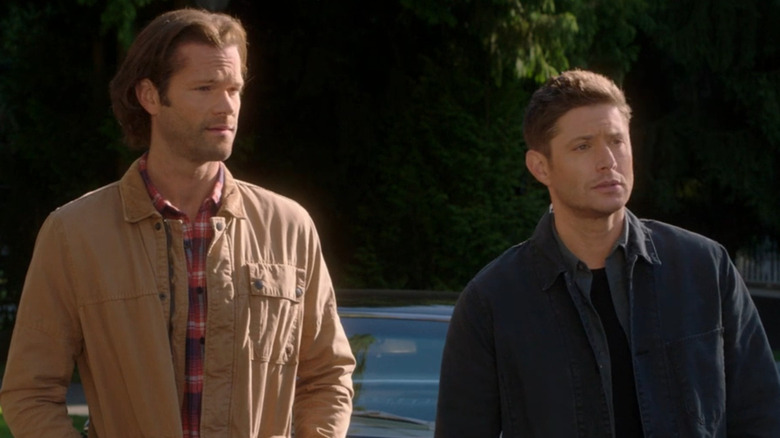 Sam and Dean Winchester standing side-by-side on Supernatural