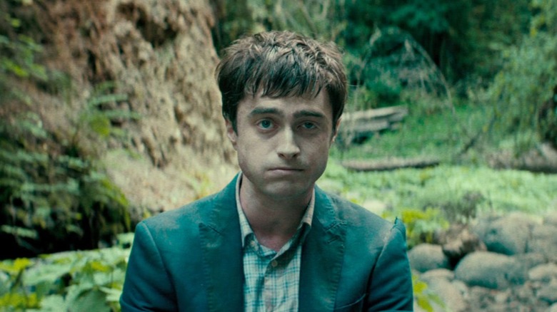 Daniel Radcliffe sitting in the woods in Swiss Army Man