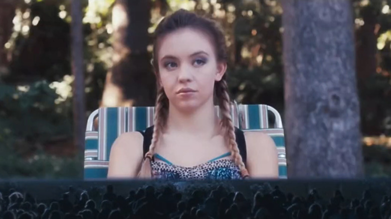 Shooting Star #2 on a big screen with a crowd of people watching her in Under the Silver Lake