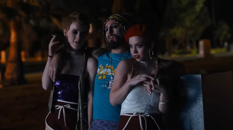Two of the Shooting Stars and a wastoid artist in a cemetery in Under the Silver Lake