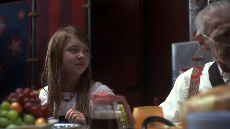 A little girl at a dinner table on the TV series Heroes