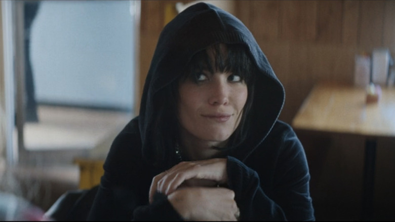 Halsey's Mandy Starr looks up at someone offscreen as she smiles in Americana