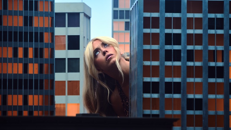 Giant Cassie looking up confused between buildings on Euphoria