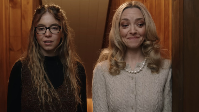 Sydney Sweeney's Millie Calloway stands next to Amanda Seyfried's Nina Winchester in The Housemaid