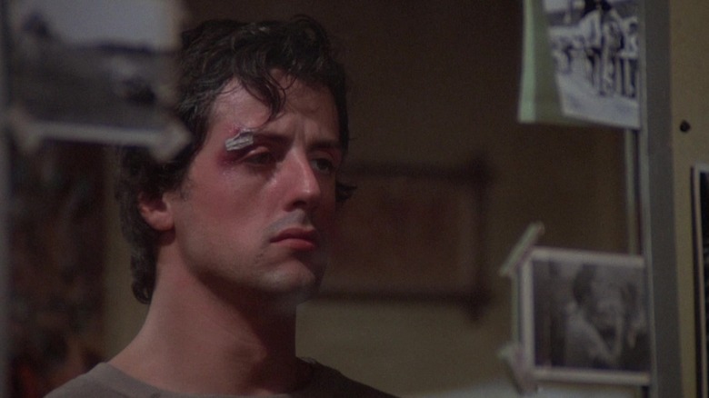 Sylvester Stallone's Rocky Balboa looks at himself in the mirror in Rocky