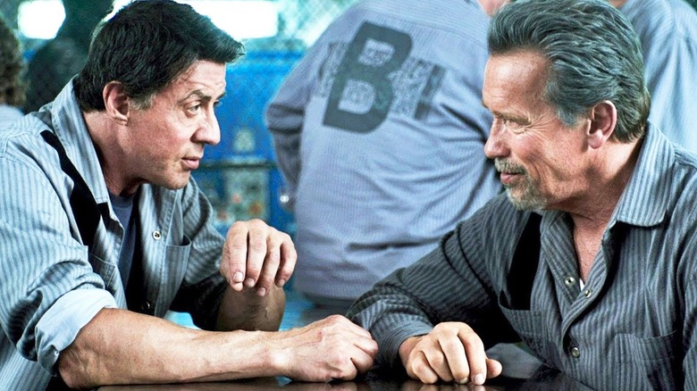 Sylvester Stallone as Ray Breslin chats with Arnold Schwarzenegger as Emil Rottmayer in Escape Plan