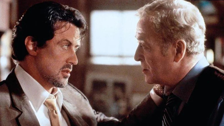Sylvester Stallone's Jack Carter puts his hand on the shoulder of Michael Caine's Cliff Brumby in Get Carter
