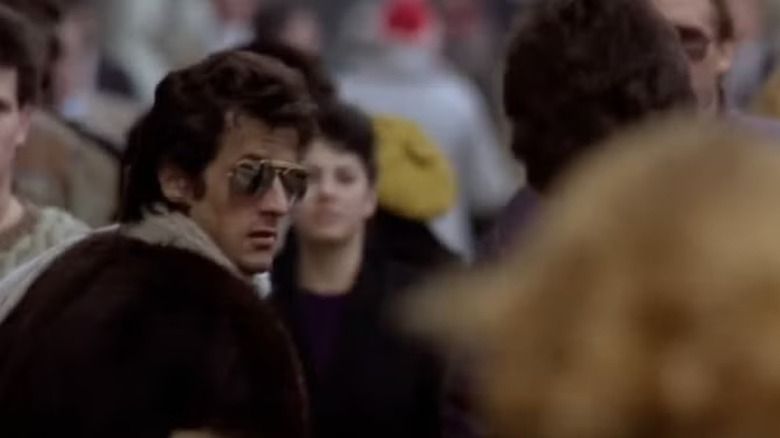 Sylvester Stallone as possibly himself looks back at John Travolta as Tony Manero in Staying Alive