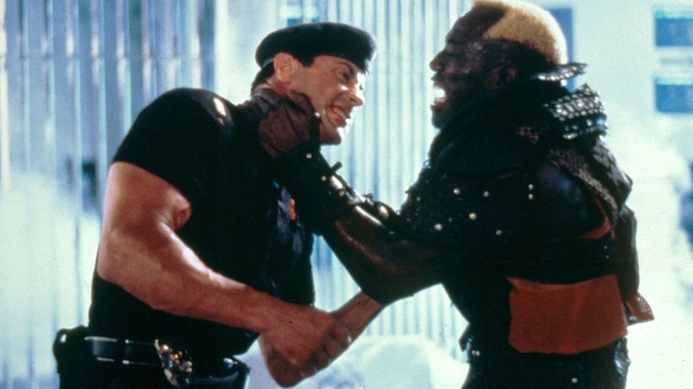 Wesley Snipes as Simon Phoenix holds Sylvester Stallone as John Spartan in a chokehold in Demolition Man