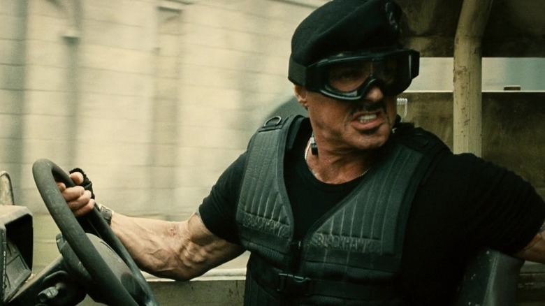 Barney Ross in a vehicle and goggles in The Expendables 2