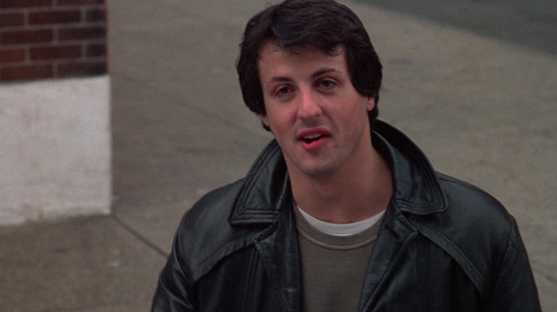 Sylvester Stallone as Rocky Balboa smiling in Rocky