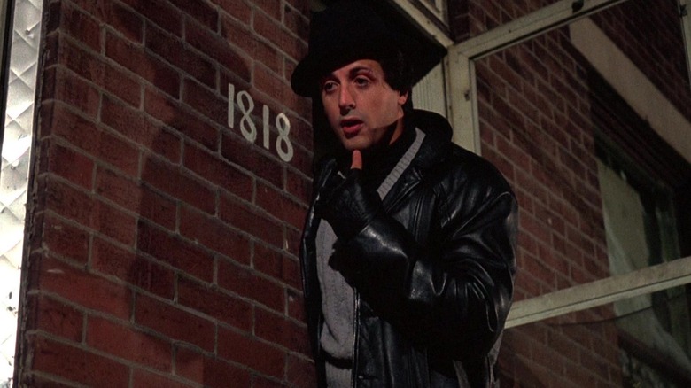Rocky Balboa (Sylvester Stallone) pointing at himself outside his apartment in Rocky
