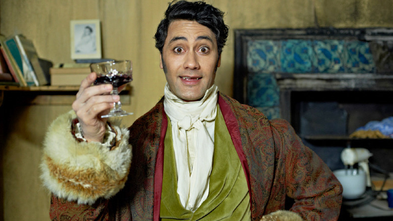 Taika Waititi with a glass of blood in What We Do in the Shadows