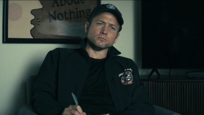 Taron Egerton as Dave Gudsen in Smoke writing on a notepad