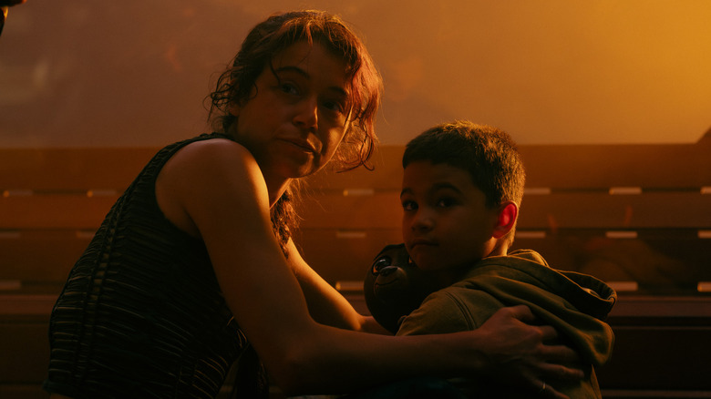 Tatiana Maslany as Anisha guarding Solen Morales as Young Caleb in Star Trek: Starfleet Academy, episode 1, season 1