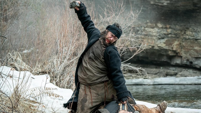 Taylor Kitsch as Isaac preparing to kill his enemy with a rock in American Primeval