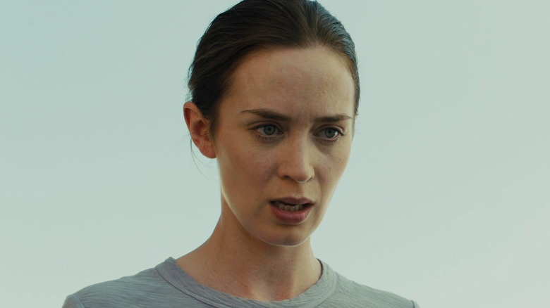 Emily Blunt's Kate Macer stands against a clear sky in Sicario