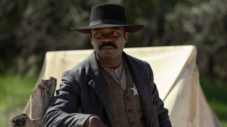 David Oyelowo as Bass Reeves leaning on a log in Lawmen: Bass Reeves
