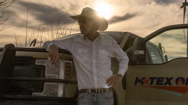 Billy Bob Thornton as Tommy Norris standing in front of his oil truck in Landman