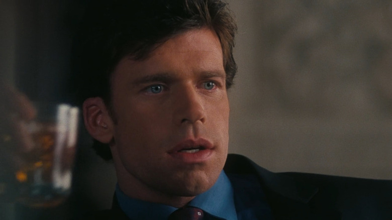 Tug (Taylor Sheridan) holding a glass in White Rush