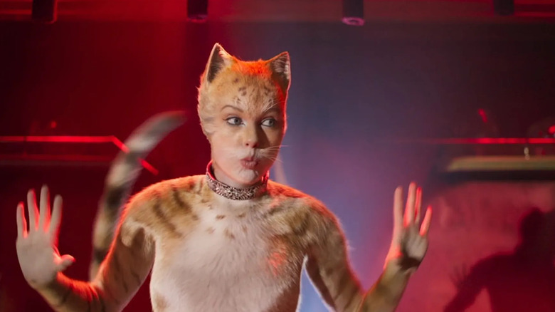 Bombalurina (Taylor Swift) with her hands up in Cats