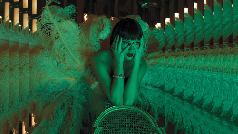 Taylor Swift in a feathered costume surrounded by mirrors in the trailer for The Official Release Party of a Showgirl