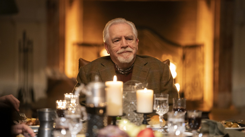 Logan Roy at the head of a table smirking on Succession