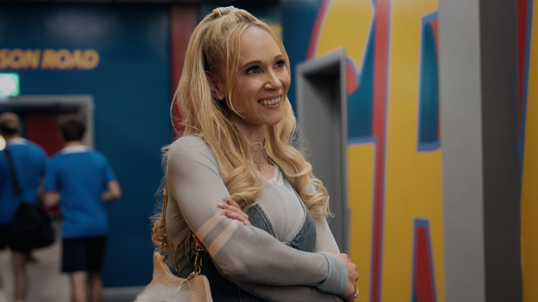 Keeley smiles with her arms crossed in the AFC Richmond hallway in Ted Lasso Season 4