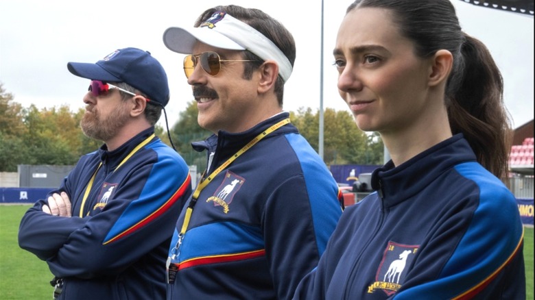 Ted, Coach Beard, and Tanya Reynolds' assistant coach watch their team in the Ted Lasso teaser