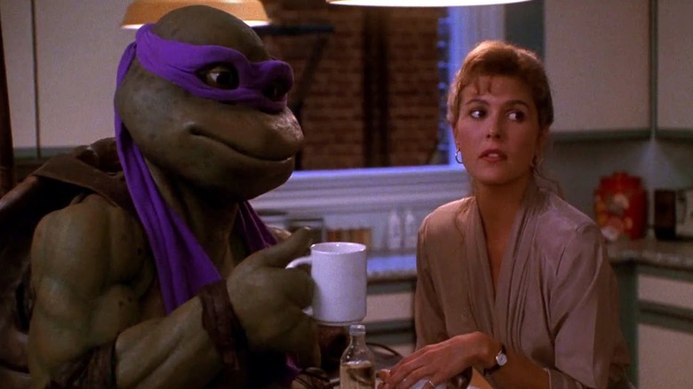 Donatello and April hold coffee cups