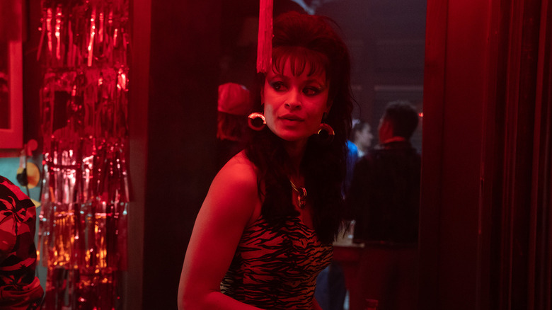 Pippa dressed up at a party in red light in Tell Me Lies