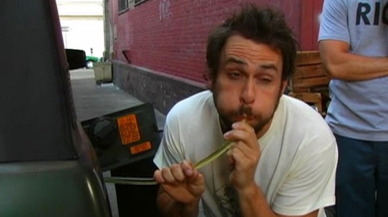 Charlie drinking gasoline from a car on It's Always Sunny in Philadelphia