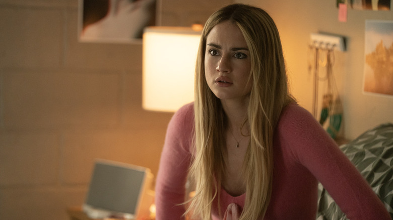 Lucy looking horrified in her room in a pink top on Tell Me Lies