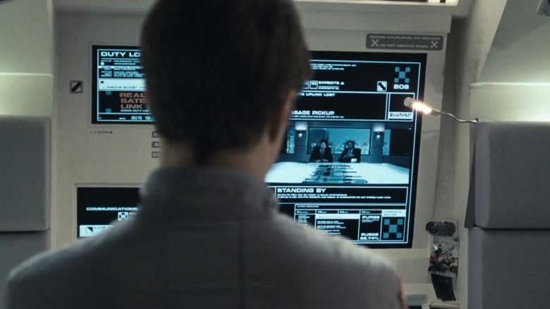 figure facing monitor