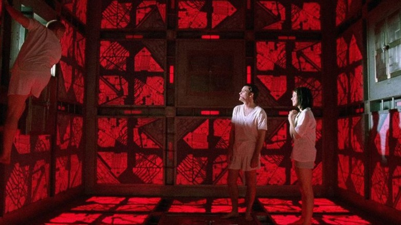Three people in red room, Cube
