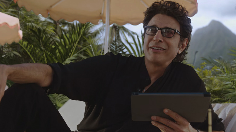 A digitally de-aged Jeff Goldblum as Ian Malcolm lounges with a tablet