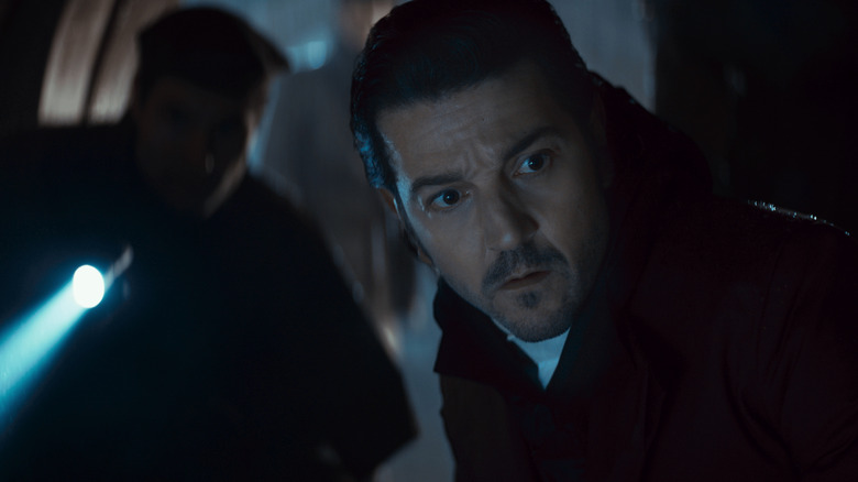 Diego Luna as Cassian Andor inspecting a dark tunnel in Andor season 2