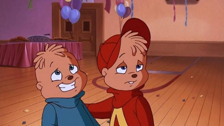 Theodore fakes a smile while Alvin looks on from the sidelines in Alvin and the Chipmunks Meet the Wolf Man.