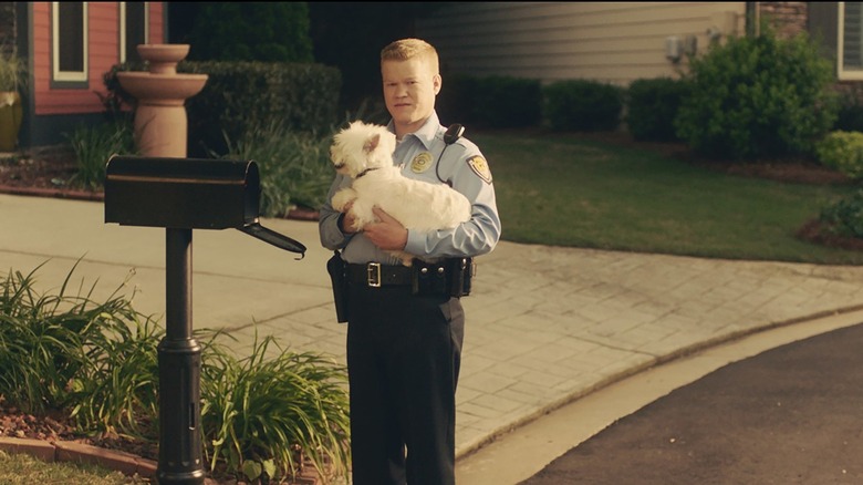 Gary holding Bastian the dog by his mailbox in Game Night