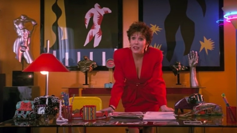 Betsy Faye Sharon standing over a desk
