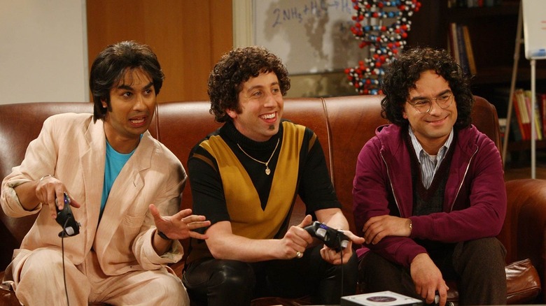 Raj, Howard, and Leonard in '90s fashion sitting on the couch in The Big Bang Theory