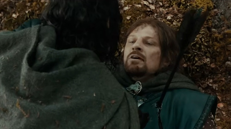 Aragorn kneeling beside Boromir