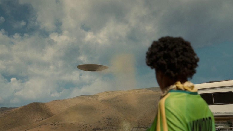 Keke Palmer as Em, watching the UFO-shaped alien Jean Jacket, in Nope